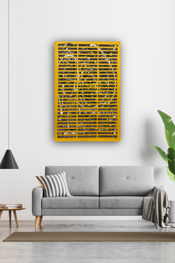 Gold abstract wall art on a white wall above a gray sofa.