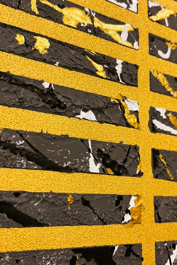 Close-up of a textured surface with gold and grey patterns