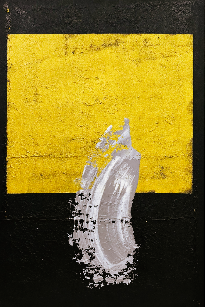 Abstract art piece with a yellow square and white brushstroke on a black background